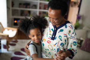 Grand daugther and grandmother dancing at living room Grand daugther and grandmother dancing at living room