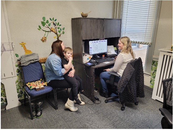 Mom and child speaking with WIC Nutritionist in WIC intake room for an in person appt